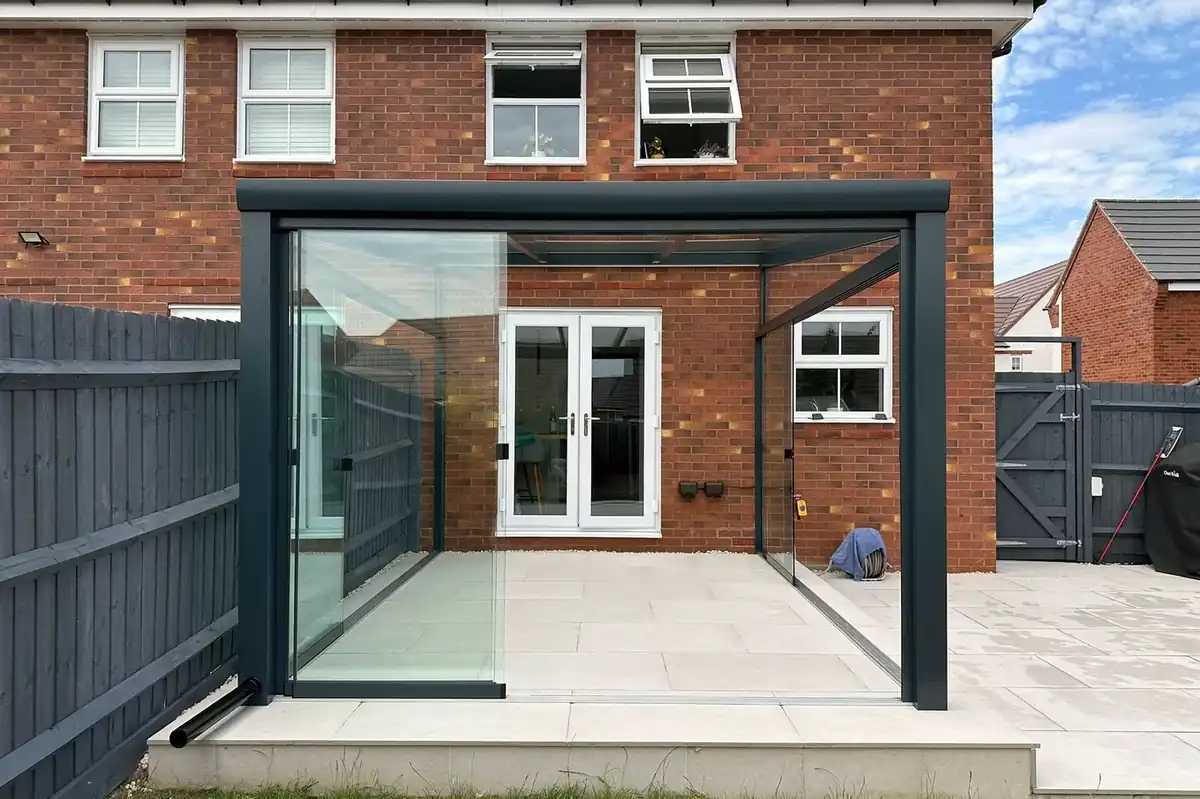 Anthracite glass room with sliding glass walls in Southam, Warwickshire